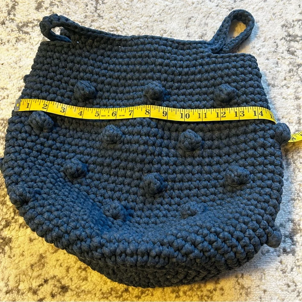 Hand-crocheted blue tote bag with bobble stitch details.